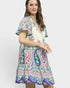 Woman wearing a colorful patterned dress on a white background