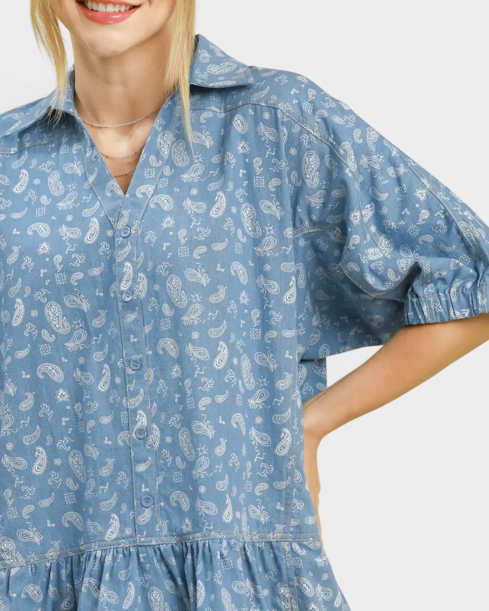 Woman wearing a blue patterned dress on a white background