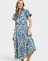 Woman wearing a blue and white patterned dress on a white background