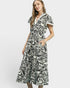 Woman wearing a black and white patterned dress on a white background