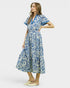 Woman wearing a blue and white patterned dress on a white background
