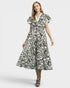 Woman wearing a black and white patterned dress on a white background