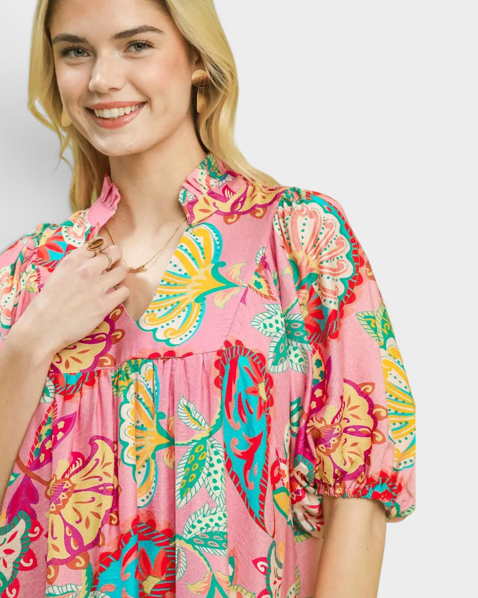 Woman wearing a colorful floral dress on a white background