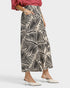Person wearing a patterned skirt on a white background