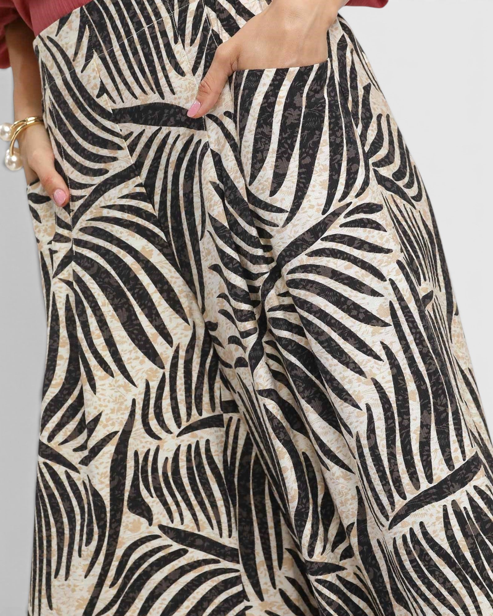 Close-up of a person wearing a patterned outfit with black and beige design.
