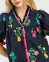 Navy dress with colorful floral embroidery on a white background