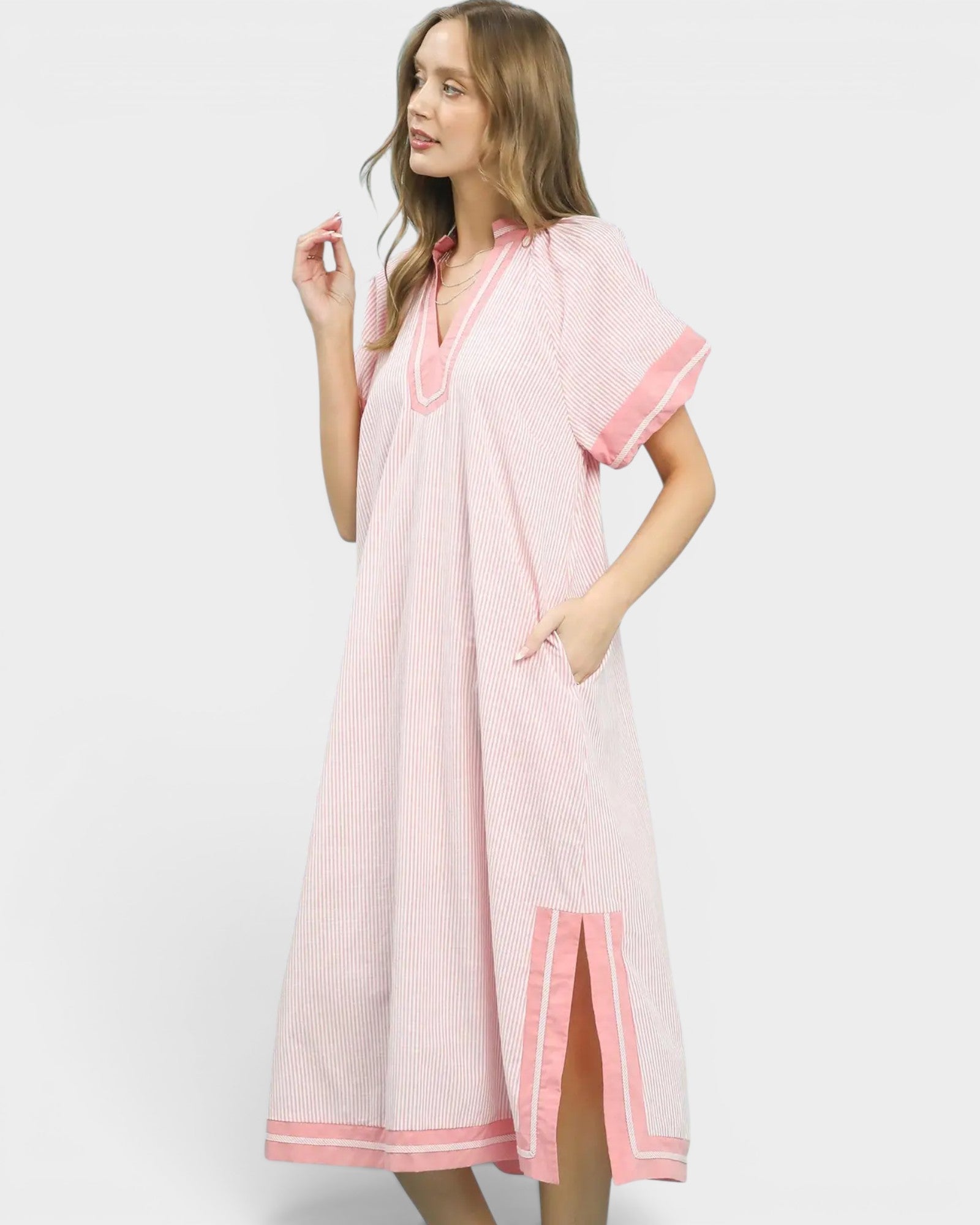 Woman wearing a pink dress with white background