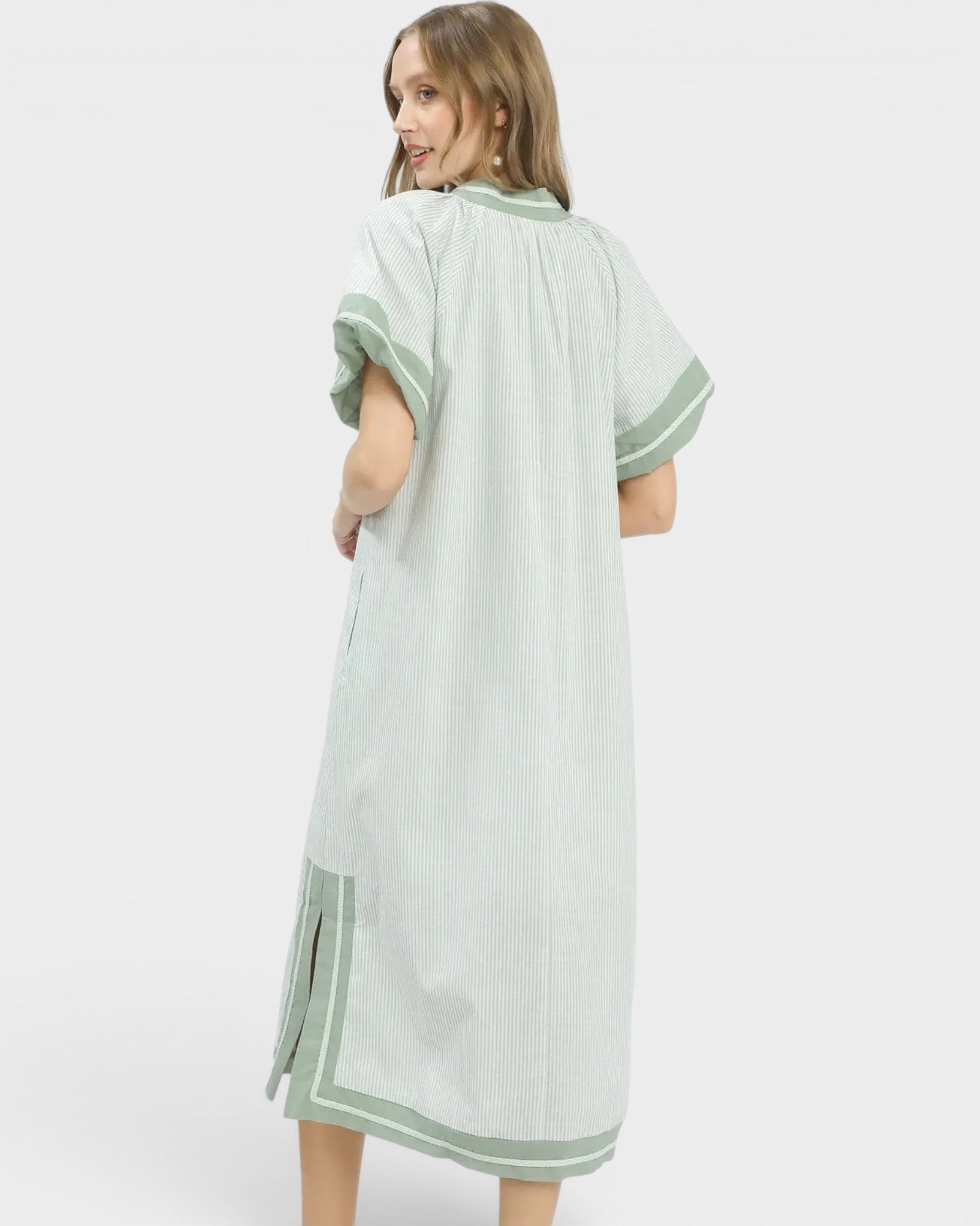 Woman wearing a light green dress with white background