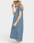 Woman wearing a blue striped dress and straw hat on a white background