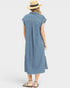 Woman wearing a blue striped dress and straw hat on a white background