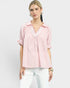 Woman wearing a pink striped blouse with a white background