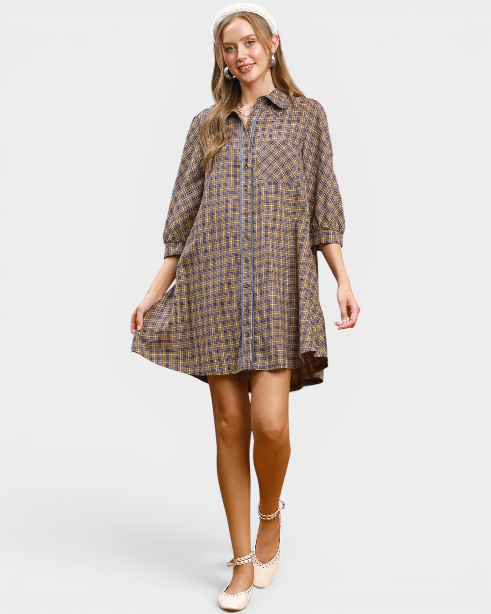Woman wearing a plaid dress on a white background