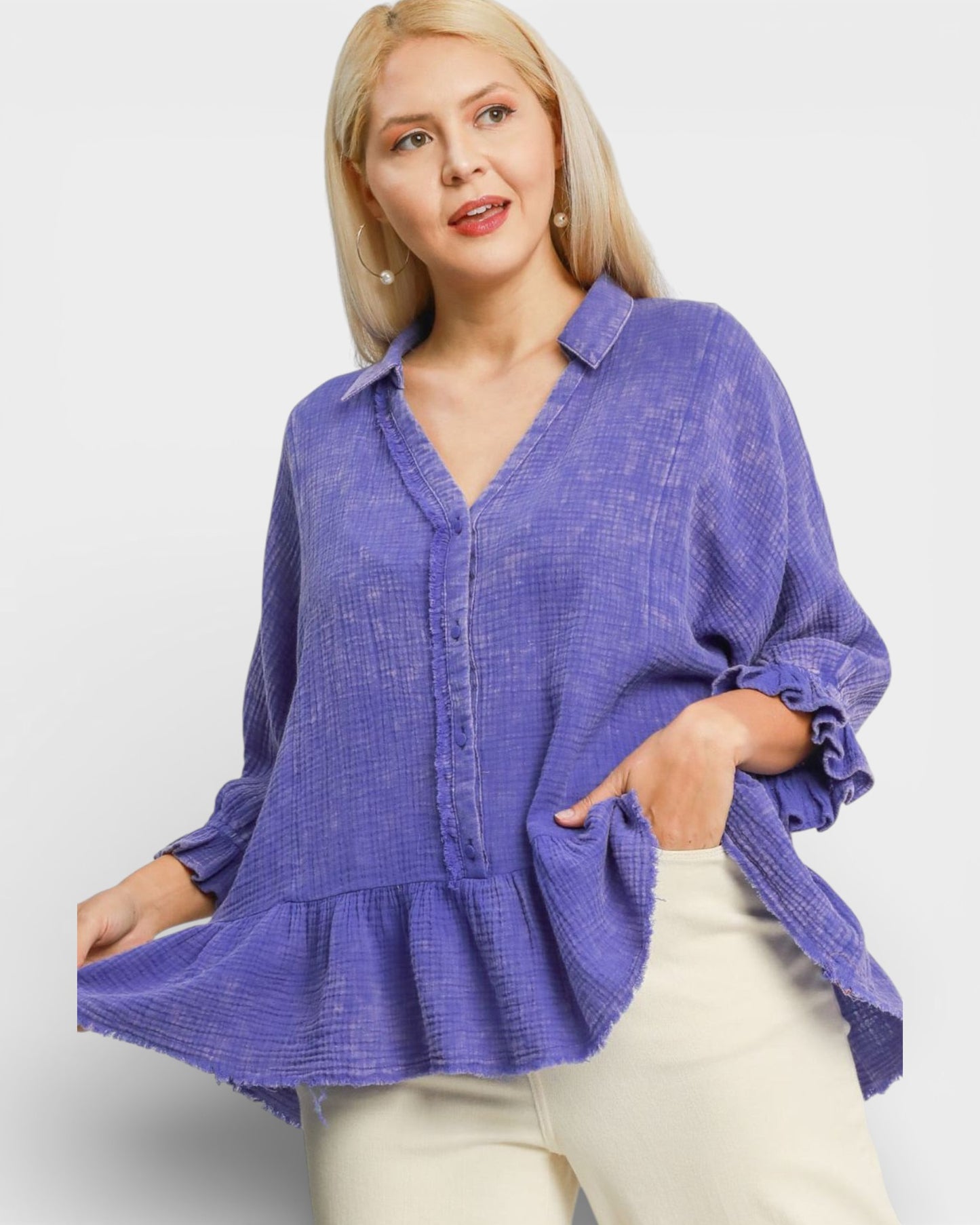 Woman wearing a purple textured blouse with a white background