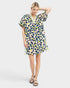 Woman wearing a colorful polka dot dress on a white background