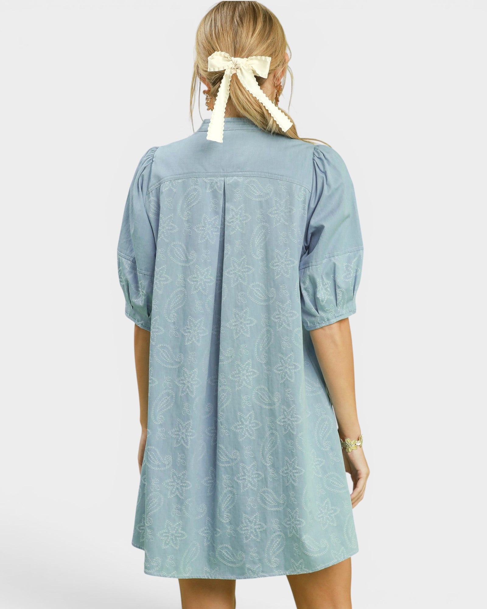 Light blue dress worn by a person on a white background