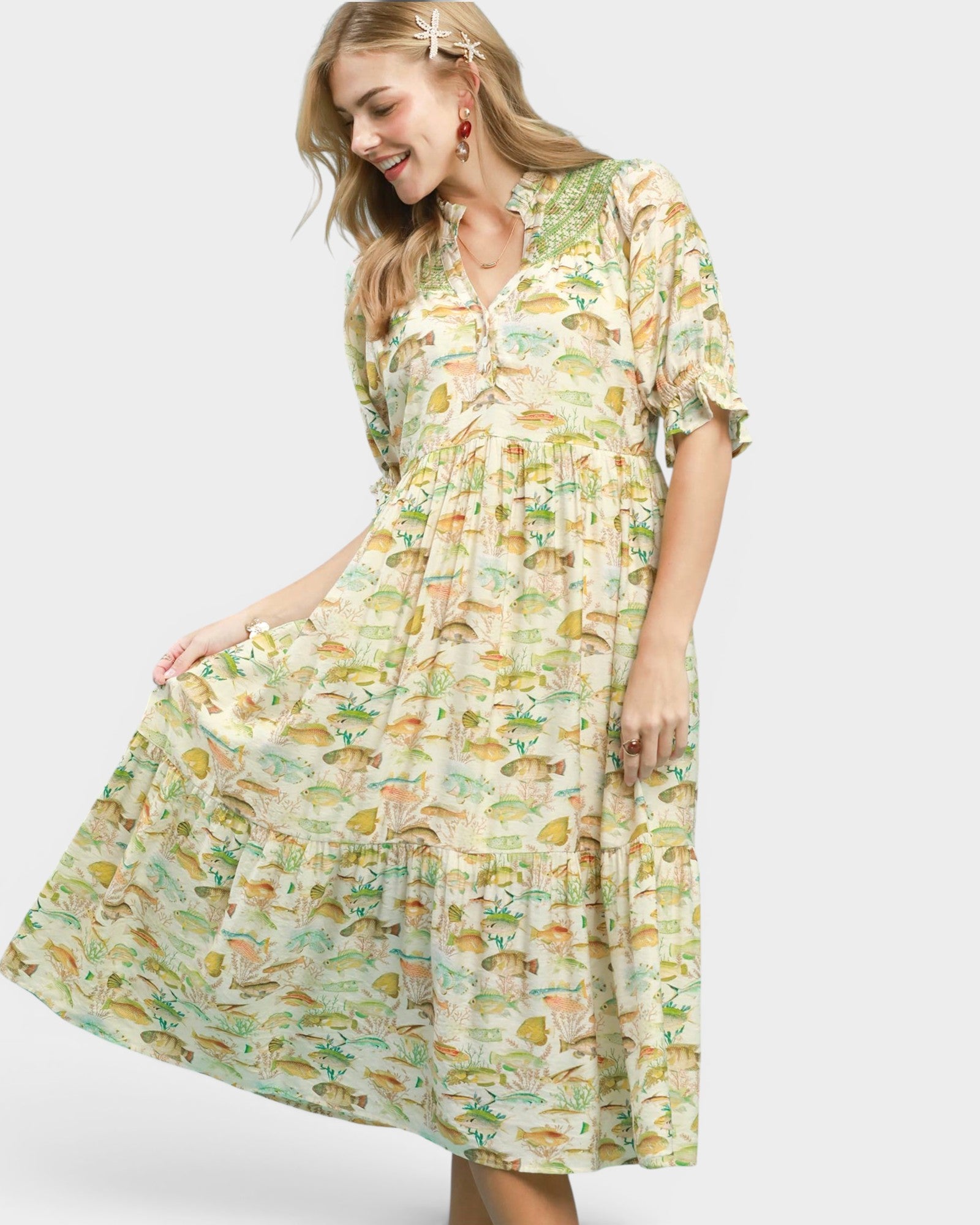 Woman wearing a fish print dress on a white background