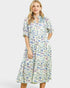 Woman wearing a fish print dress on a white background