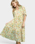 Woman wearing a fish print dress on a white background