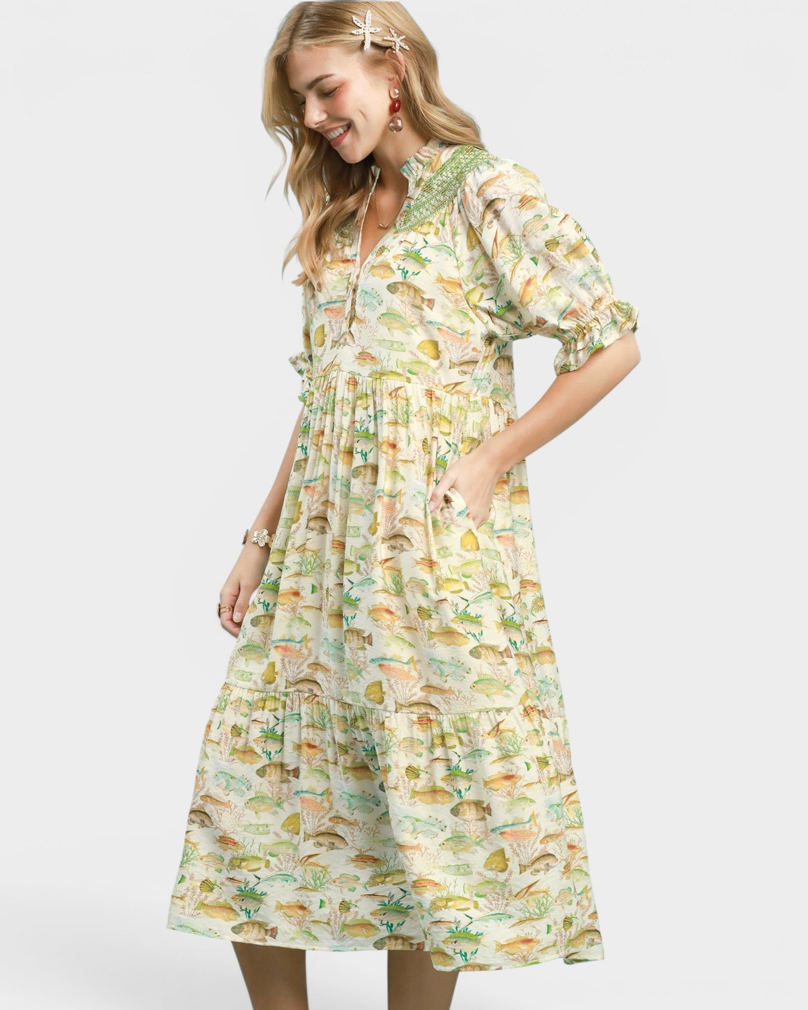 Woman wearing a fish print dress on a white background