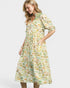 Woman wearing a fish print dress on a white background