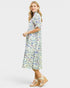 Woman wearing a fish print dress on a white background