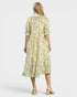 Woman wearing a fish print dress on a white background