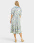 Woman wearing a fish print dress on a white background