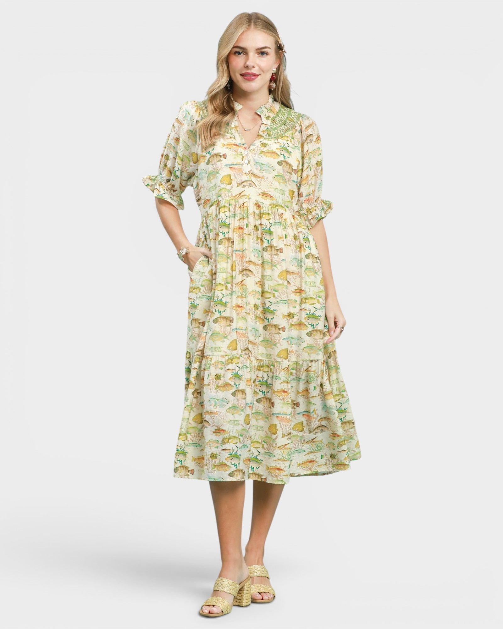 Woman wearing a fish print dress on a white background