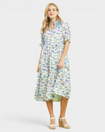 Woman wearing a fish print dress on a white background