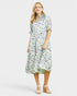 Woman wearing a fish print dress on a white background