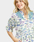 Woman wearing a fish print dress on a white background