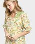 Woman wearing a fish print dress on a white background