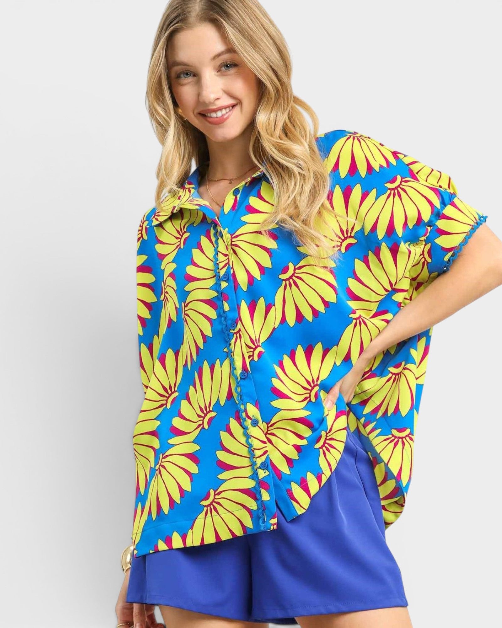Woman wearing a colorful floral shirt with a blue background