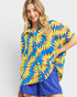 Woman wearing a colorful floral shirt with a blue background