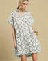 Woman wearing a patterned dress on a beige background