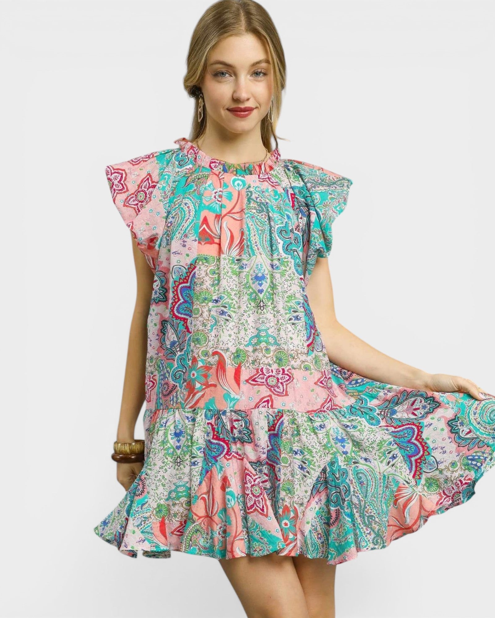 Woman wearing a colorful patterned dress on a white background
