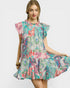 Woman wearing a colorful patterned dress on a white background
