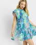 Woman wearing a colorful patterned dress on a white background