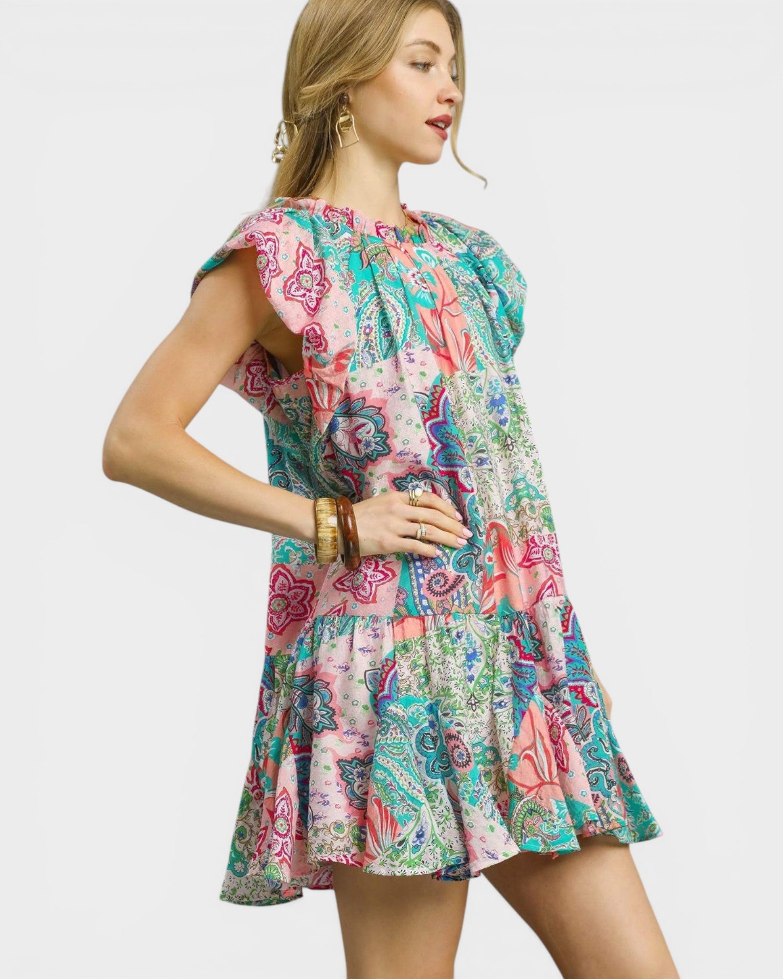 Woman wearing a colorful patterned dress on a white background