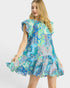 Woman wearing a colorful patterned dress on a white background