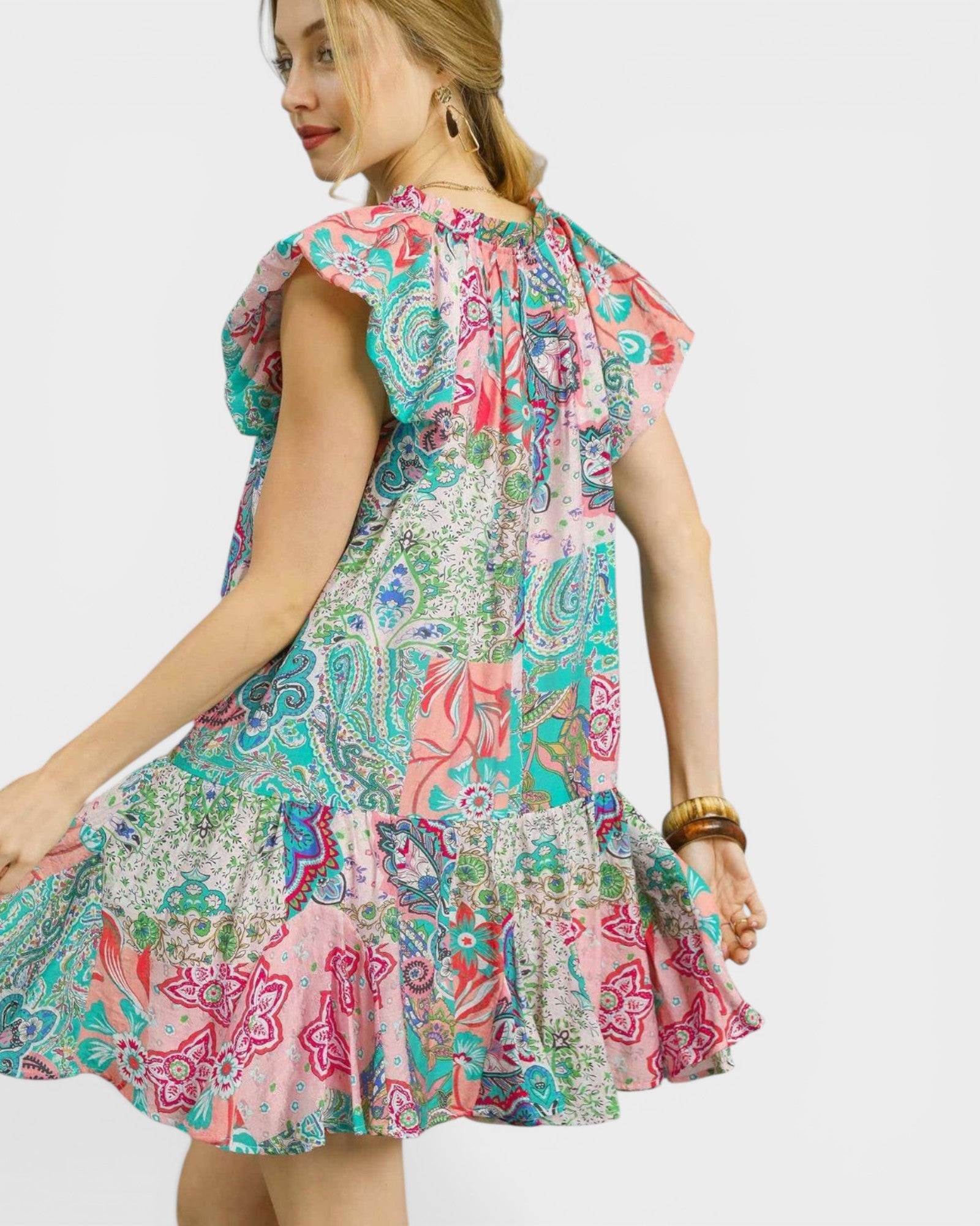 Woman wearing a colorful patterned dress on a white background