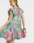 Woman wearing a colorful patterned dress on a white background