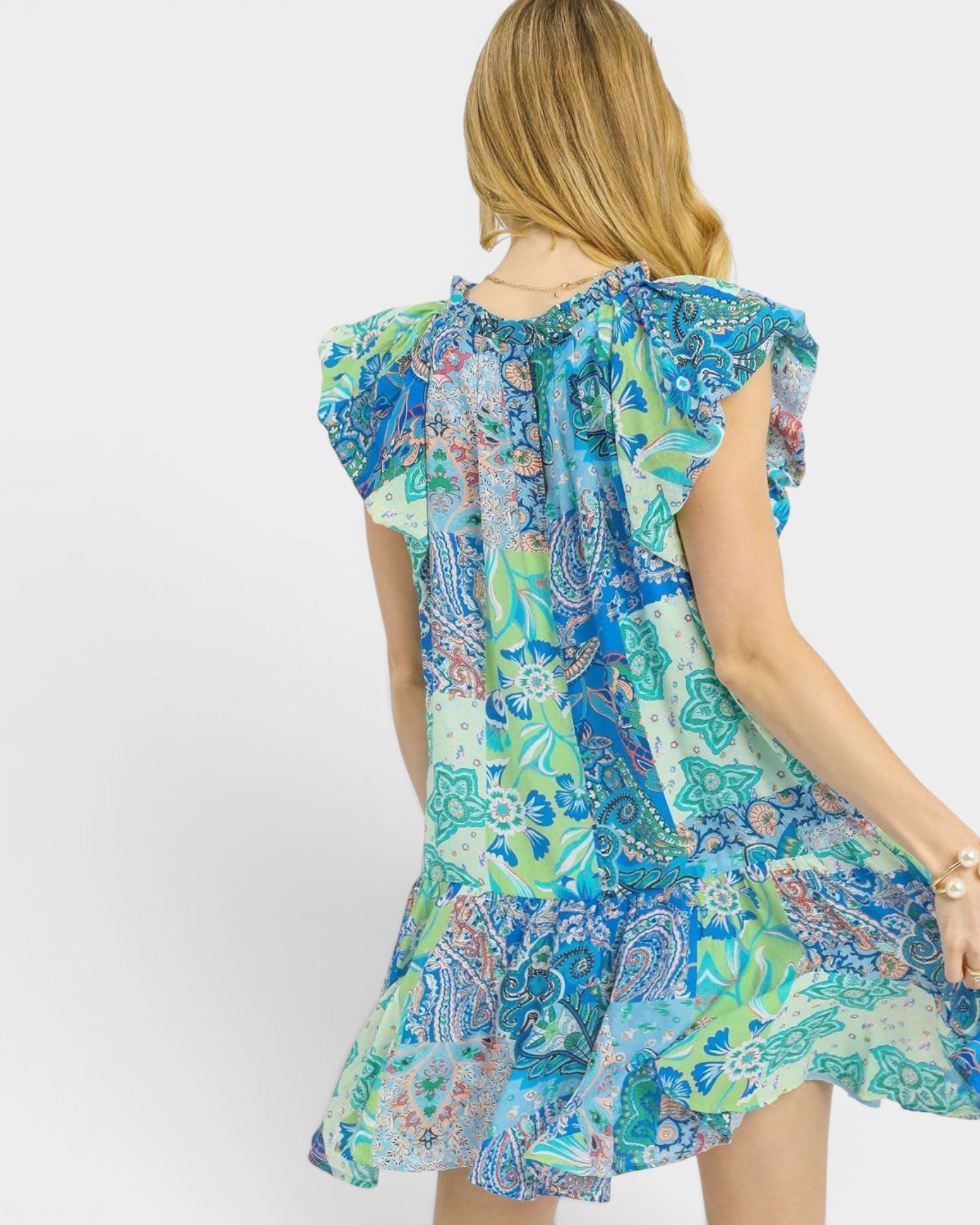 Woman wearing a colorful patterned dress on a white background