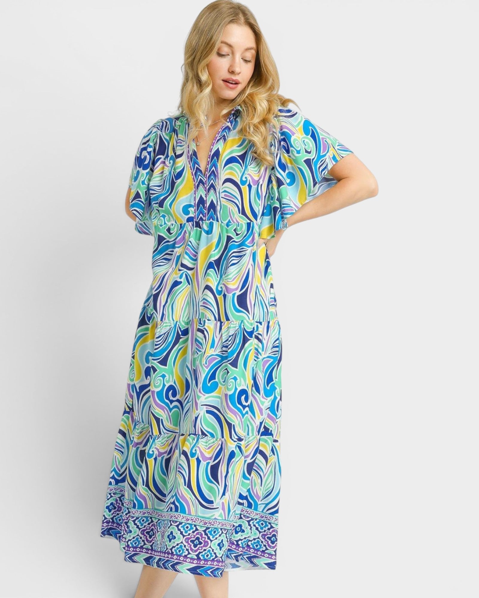 Woman wearing a colorful patterned dress on a white background