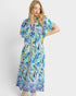 Woman wearing a colorful patterned dress on a white background