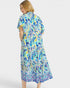 Woman wearing a colorful patterned dress on a white background