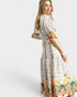 Woman wearing a patterned dress on a white background