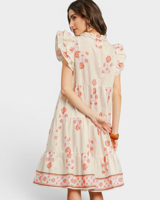Woman wearing a floral dress with a plain background