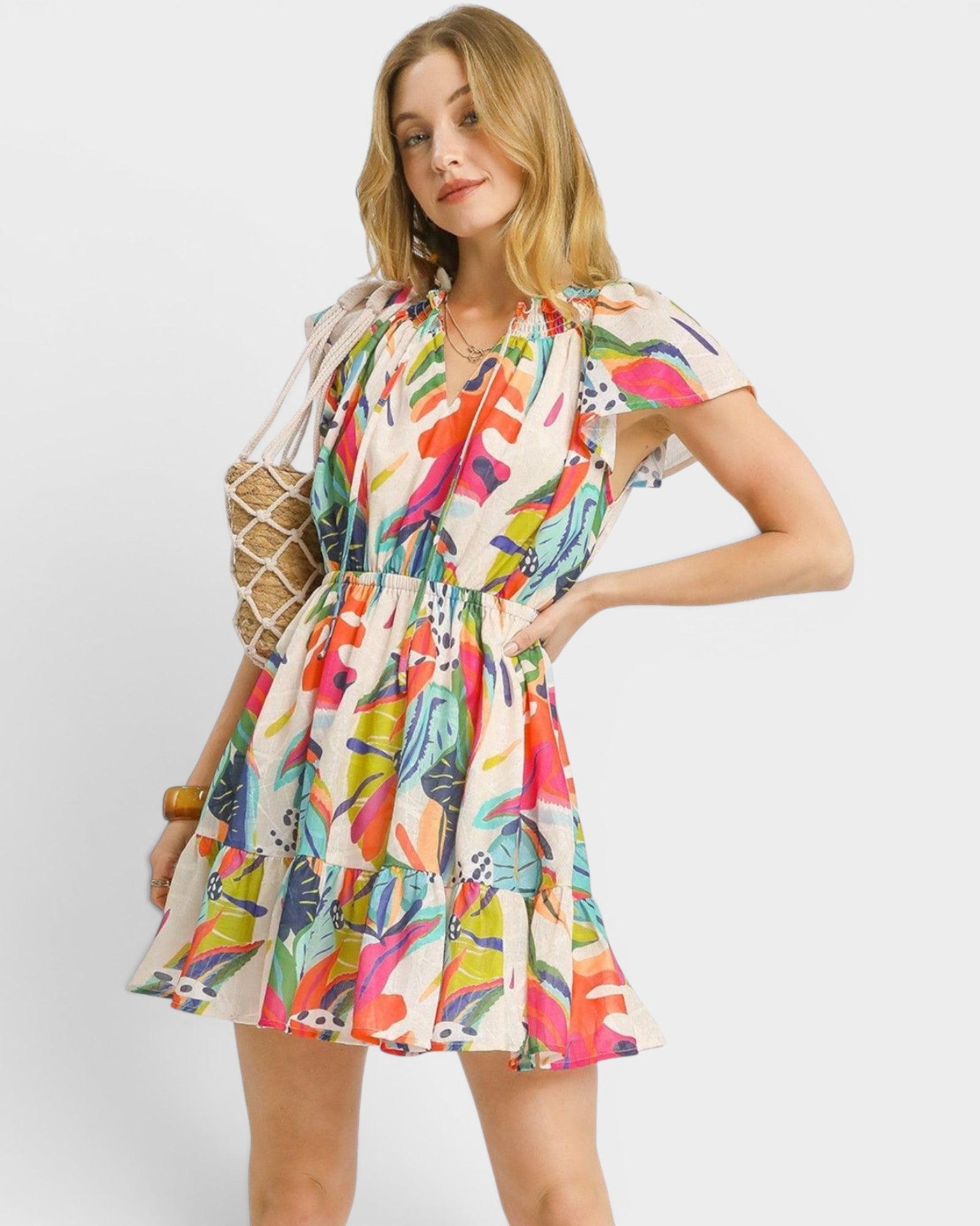 Woman wearing a colorful floral dress on a white background