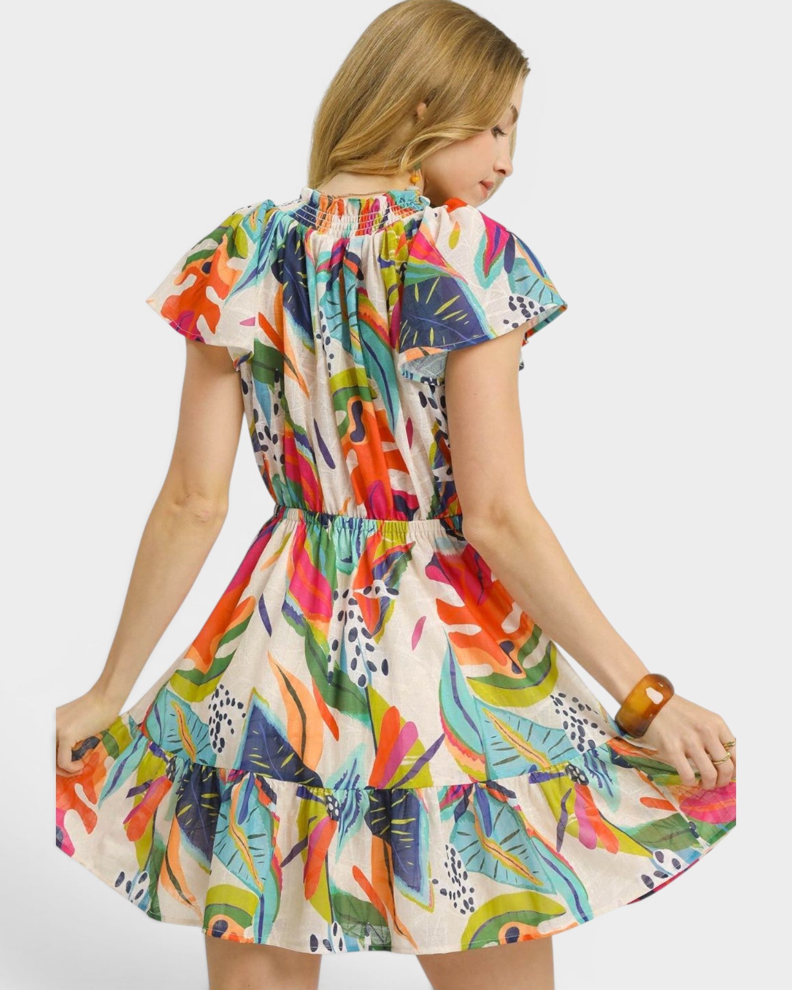 Woman wearing a colorful patterned dress on a white background